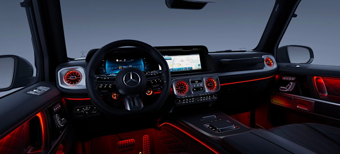 Plancia della Mercedes-AMG G 63 con volante performance AMG, display MBUX e luci ambient